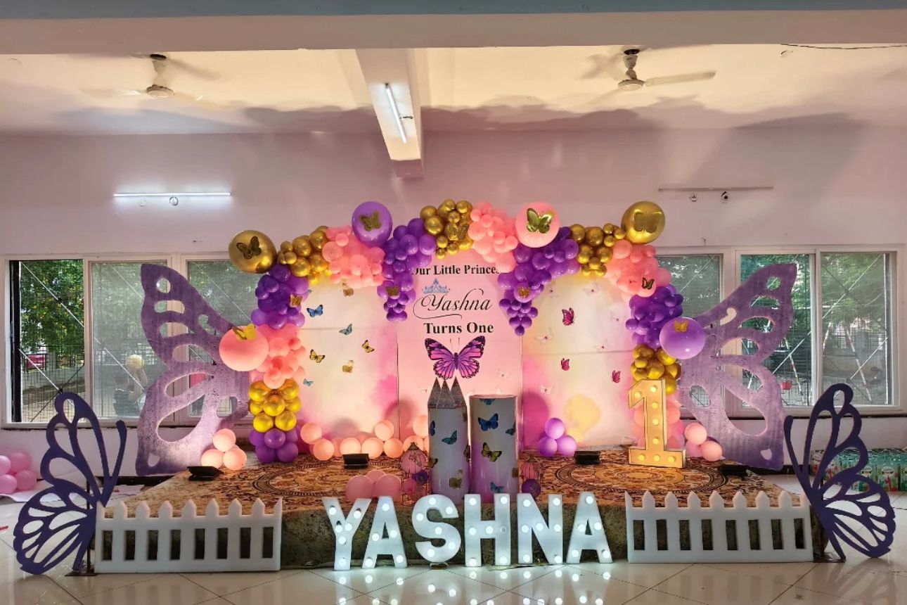 Butterfly Theme First Birthday Decoration Setup | Pink, Purple & Gold Balloon Backdrop with Fairy Wings